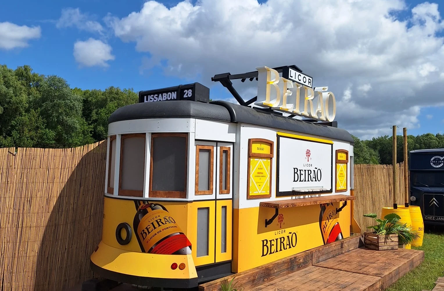 A sunny yellow Licor Beirão tram transformed into a custom-built festival bar