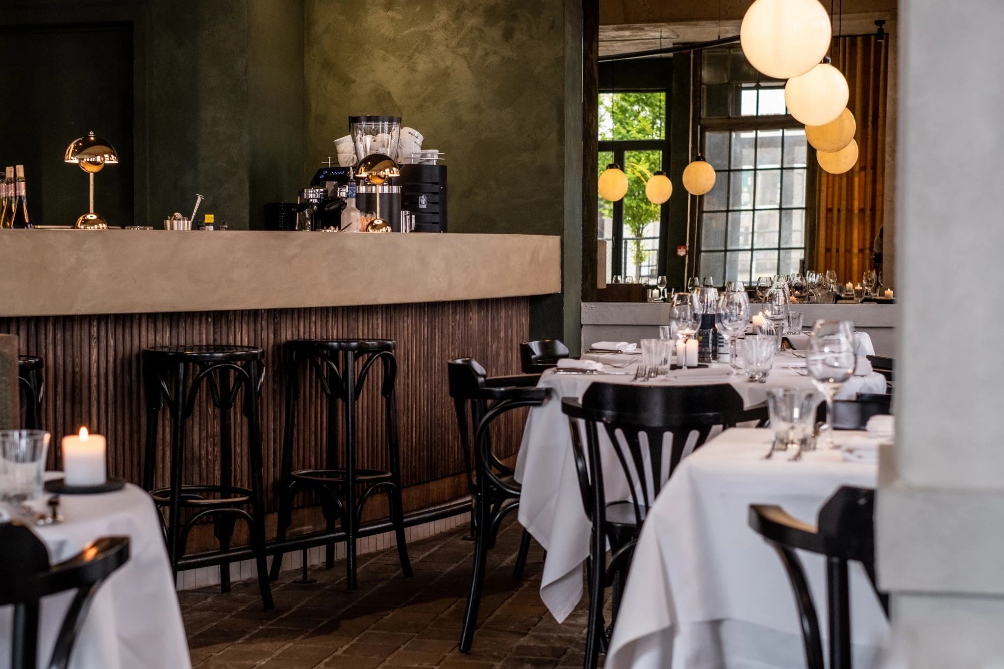 The Repasse restaurant interior with a timber bar and warm globe lighting